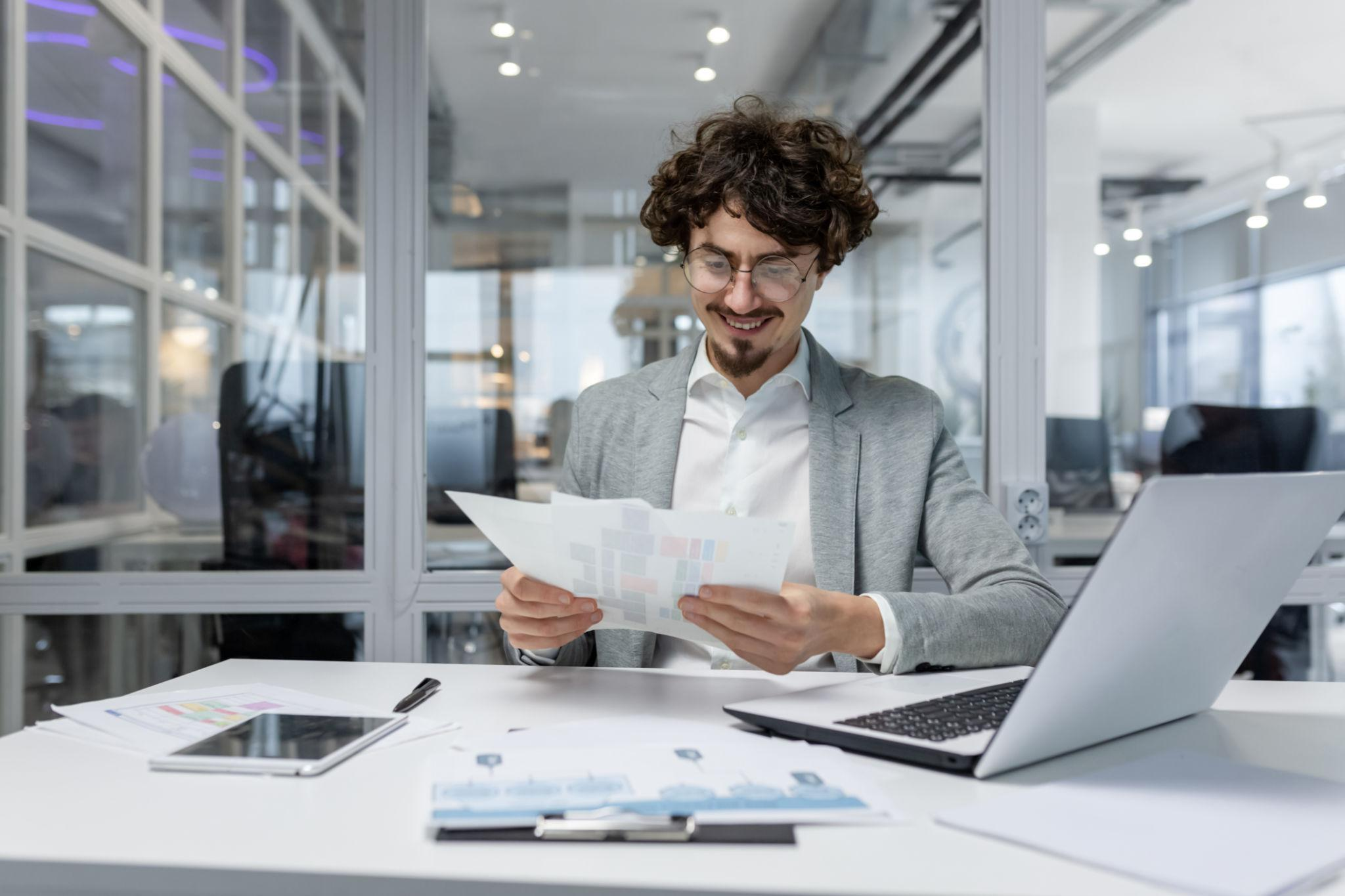 Professional working on financial data at a laptop